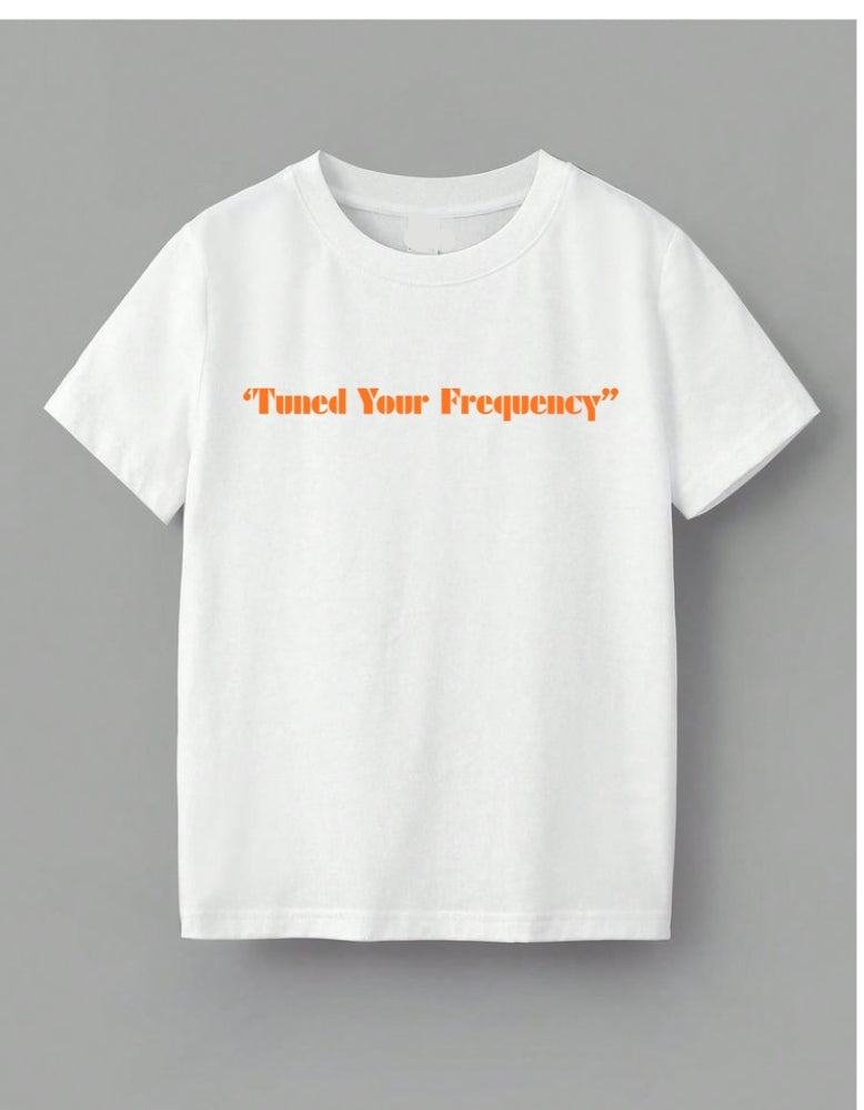 White t-shirt with 'Tuned Your Frequency' text in orange on a gray background