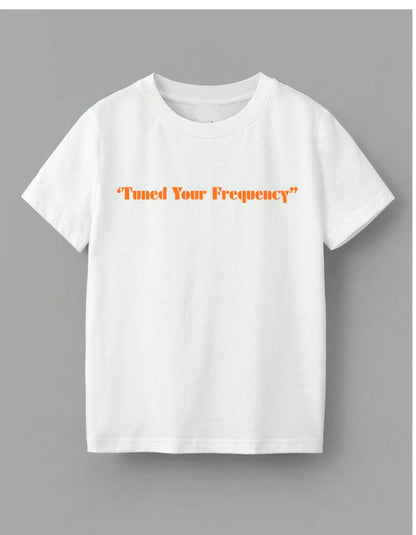 White t-shirt with 'Tuned Your Frequency' text in orange on a gray background